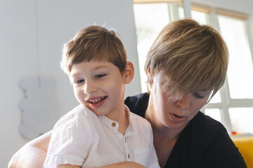 Young boy with neurodevelopmental disorders enjoys a physical rehabilitation session with a...