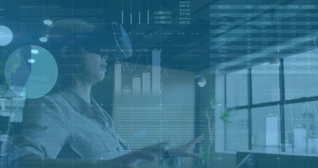 Image of financial data processing over asian businesswoman wearing vr headset
