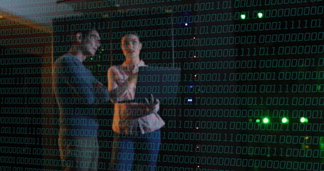 Binary code over people discussing in data center