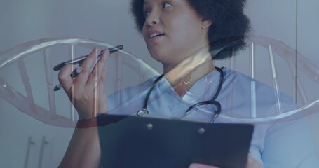 Image of dna strand over african american female doctor talking on smartphone