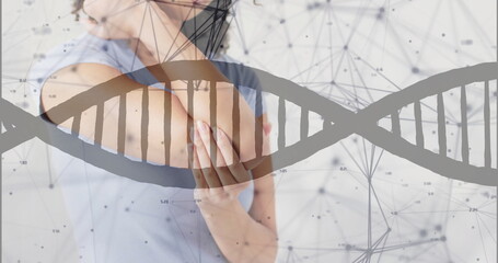 Image of dna strand and connections over african american woman holding her elbow