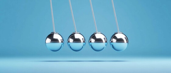 Newton Cradle, silver  balls on a blue background. Physics concept, Motion and energy transfer, Balance and equilibrium.
