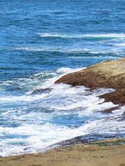 calm waves wash against rocks
