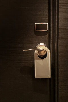 Empty tag in  do not disturb sign hanging on elegant hotel room door