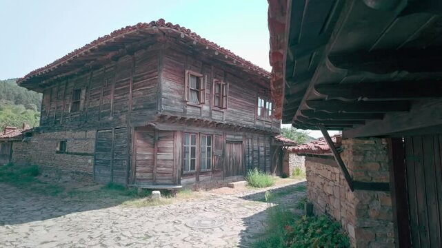 Peaceful cobbled street of Balkan traditional wooden house village