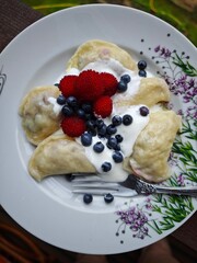 dumplings with berries. dish dessert. delicious dish. vertical photography
