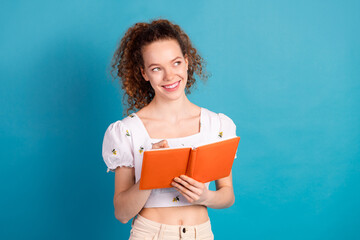 Photo portrait of attractive young woman write notebook look empty space dressed stylish white clothes isolated on blue color background