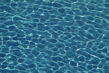 Sunlit serenity with crystal clear swimming pool water on a bright summer day outdoors