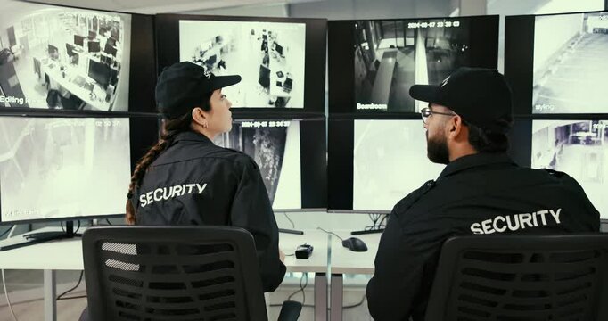 Security guard, surveillance and team in office, screen and watch of footage, people and camera. Digital, safety and protection of business, monitor and inspection of computer in back of control room