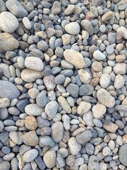 Background composed of a close-up of pebbles of different sizes and colors
