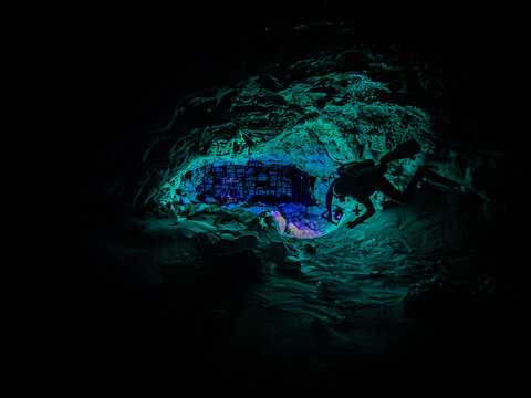 Scuba divers light up the cavern as they enter Ginnie Ballroom, Ginnie Springs, Florida