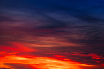 Background of the dawn sky with sunlight shining through the clouds creates a beautiful and fascinating color. 
