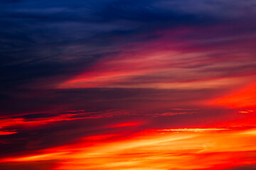 Background of the dawn sky with sunlight shining through the clouds creates a beautiful and fascinating color. 