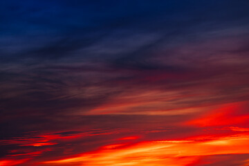 Background of the dawn sky with sunlight shining through the clouds creates a beautiful and fascinating color. 