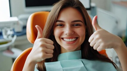 photograph of Satisfied woman patient showing her perfect smile and gesturing thumb up after treatment, sitting in dentist clinic