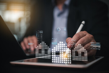 Businessman analyzing real estate market trends with digital homes and data charts, representing...