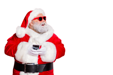 Portrait of cheerful santa claus in hat looking dreamy using cell phone plan newyear party wearing belt eyewear eyeglasses isolated over red background