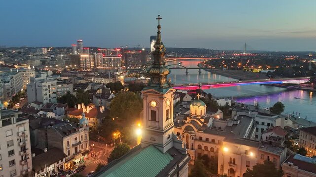 Sunset view of Belgrade with city lights. Flying over Cathedral of Saint Michael, Sava river, bridges and old town in Belgrade - capital of Serbia