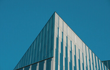 Fragments of modern buildings against the sky, capturing sleek lines, glass reflections, and bold...