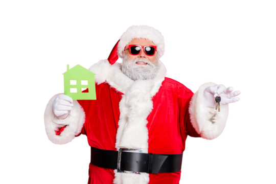Portrait of cheerful santa claus in eyewear eyeglasses holding keys and paper card building give move house present wearing hat cap belt isolated over reed background