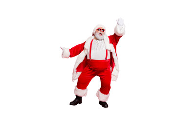 Full size photo of funny fat overweight santa claus with big abdomen raise his arm dance wear style stylish trendy eyeglasses eyewear pants trousers isolated over red background