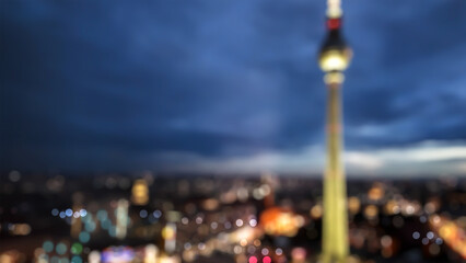 blurred Berlin Alexander Square in Germany background at night with tv tower, defocused colorful...