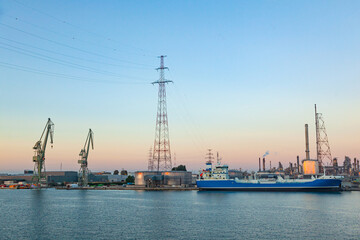 Oil ship docked at the oil berth in oil refinery.