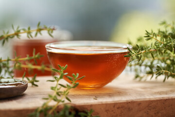 A bowl of homemade thyme syrup on a table