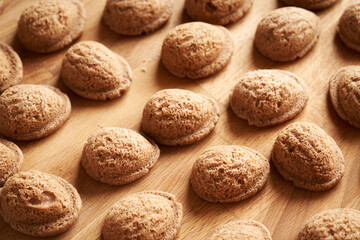 Freshly baked homemade Christmas cookies in the form of nuts on a wooden board