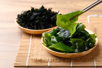 Fresh Wakame seaweed or sea mustard with chopsticks © nungning20