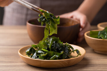 Wakame seaweed or sea mustard salad with chopsticks, Healthy eating