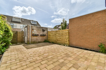 Suburban home backyard with wooden fence and paving