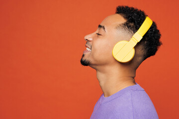 Close up side view young happy man of African American ethnicity wear purple sweatshirt casual...