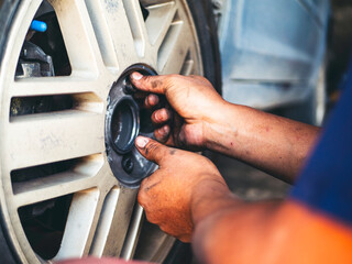 Mechanic man hands checking car tires outdoor on site service auto garage for automotive mobile...