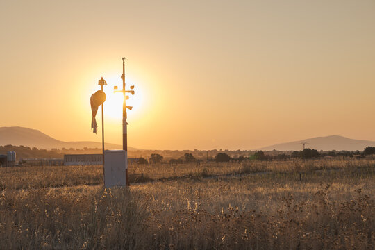 Evacuation heliport with anemometer at sunset