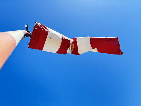 Windsock against blue sky signaling helicopter landing