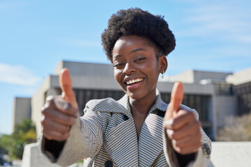 Confident Young Woman Giving Thumbs Up Outdoors