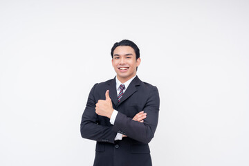 Portrait of an optimistic young asian business executive in a fashionable suit and tie. Arms crossed, giving a thumbs up. Isolated on a white background.