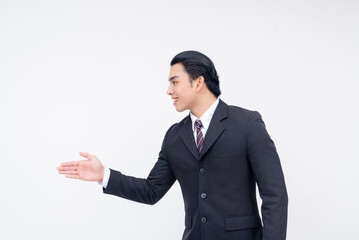 Side view of a young asian business executive offering a handshake, coming to an agreement. Isolated on a white background.