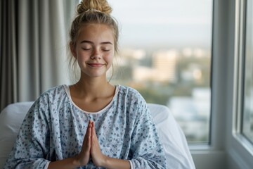 A young patient in a hospital bed practices mindfulness meditation by a sunlit window, illustrating calm and hope in the healing process.
