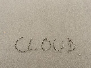 on the beach is carved with letters in the smooth sand the writing Cloud