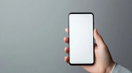 Smartphone held in a person's hand with a blank screen and a clean background