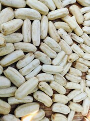 Organic thai bananas laid on a bamboo tray for sun drying.
