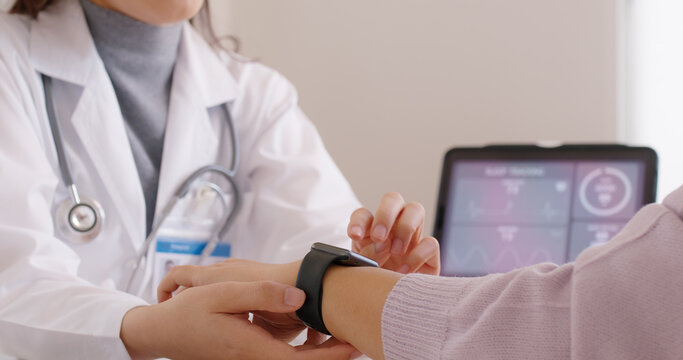 Close-up GP advice AI smart IoT watch guide to patient help collect ECG data, pulse heart rate, blood pressure, wrist sensor sport solution record connect to clinic health device digital platform app. - Powered by Adobe
