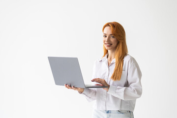 Portrait of young woman answer clients on laptopstanding over white background