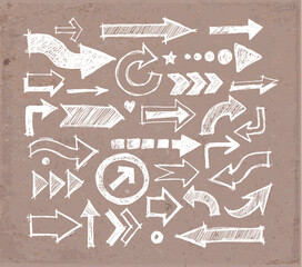 Collcetion of hand-drawn doodle sketch arrows in various styles and directions, sketched with a rough, artistic feel on brown parcel paper background