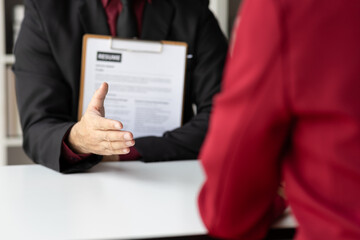 Job searching, Applicants submit application documents and resumes during job interviews in the office. Job interview