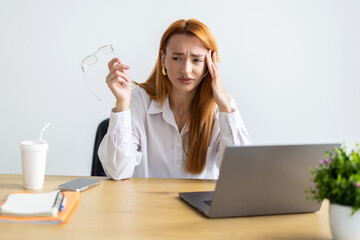 Young woman are stressed while working on laptop, Tired businesswoman with headache at office, feeling sick at work