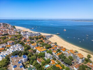 The drone aerial view of the beach and the city of Arcachon, France. Arcachon is a commune in the...