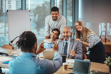 Happy Colleagues Posing for a Group Photo in Office